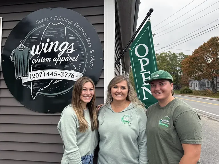 Mariah, Julie, & Ashlyn in front of their store.